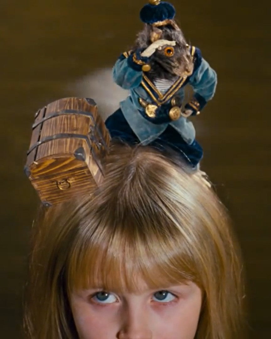 Puppet on a child's head with a wooden chest