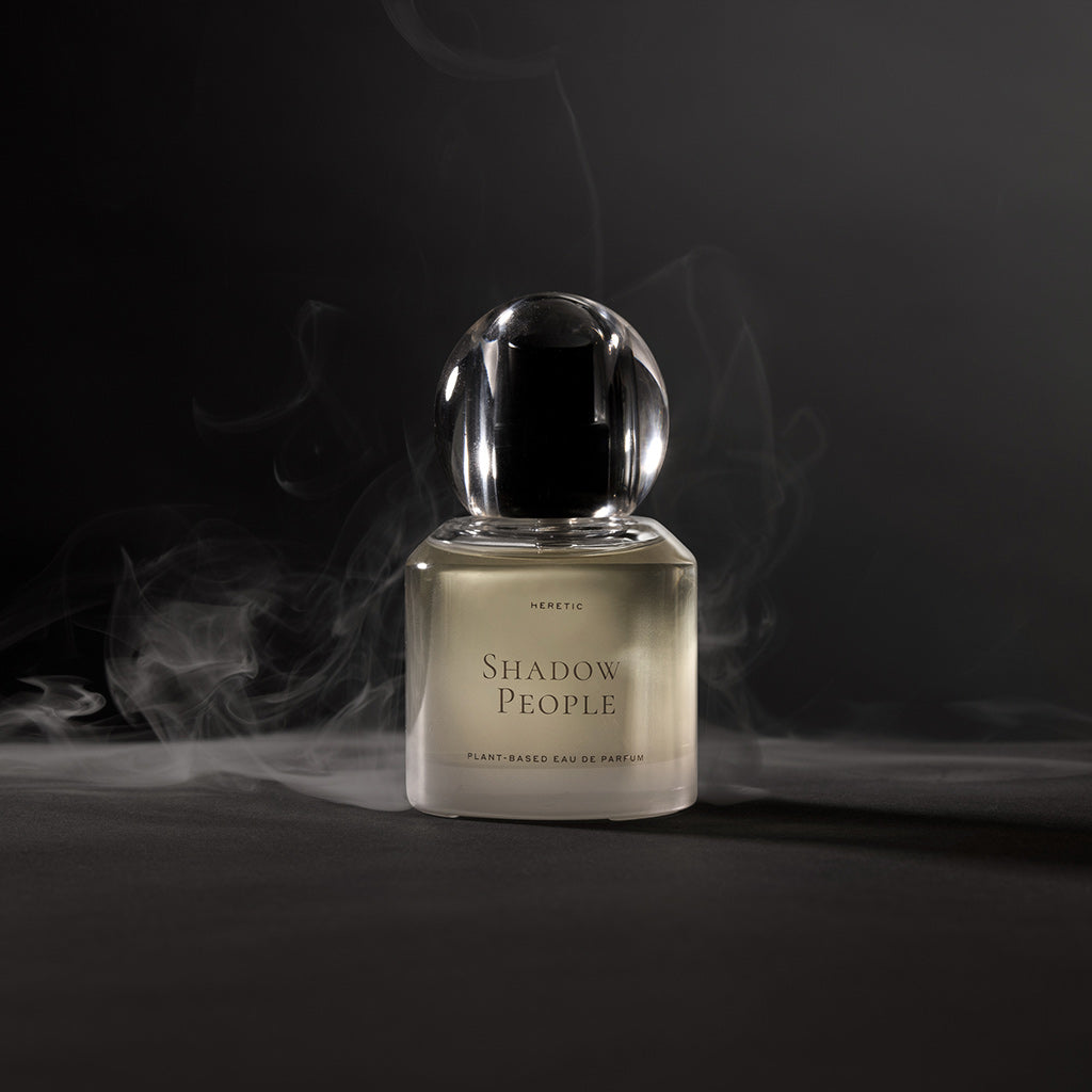 Perfume bottle labeled 'Shadow People' with a dark background and smoke effect.