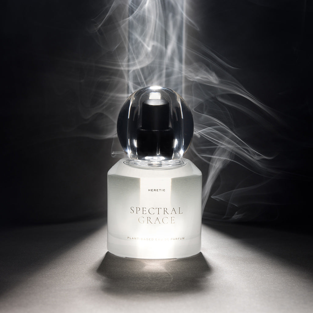Perfume bottle labeled 'Spectral Grace' with smoke effect on a dark background