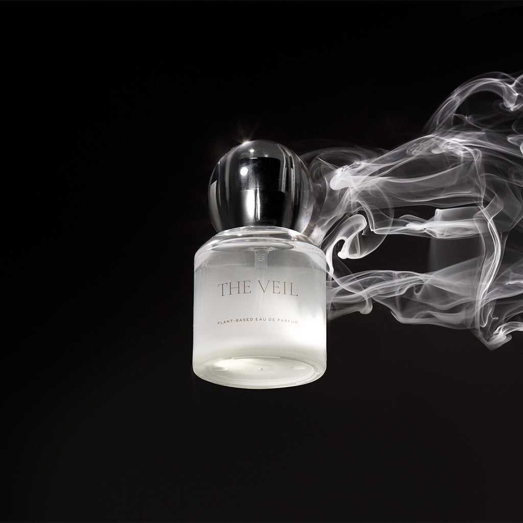 Perfume bottle labeled 'The Veil' with smoke effect on a black background